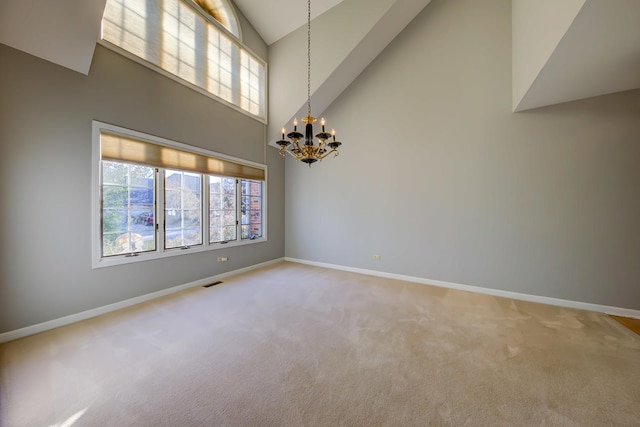 unfurnished room with light carpet, a notable chandelier, visible vents, and baseboards