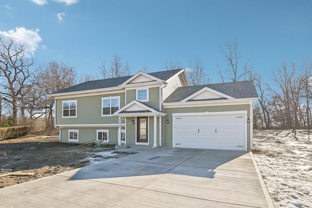 view of front facade with concrete driveway and an attached garage