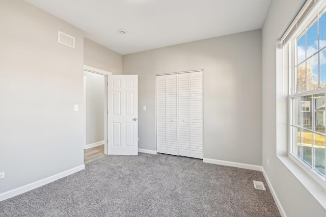 unfurnished bedroom featuring baseboards and visible vents