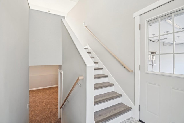 stairs with carpet and baseboards