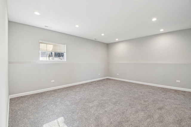 carpeted empty room featuring visible vents, baseboards, and recessed lighting