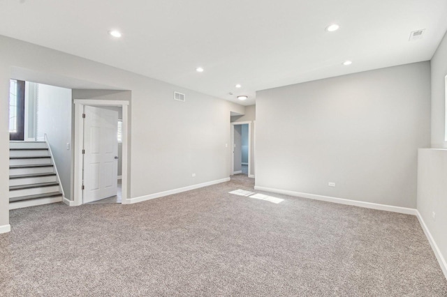 carpeted empty room featuring recessed lighting, visible vents, stairway, and baseboards