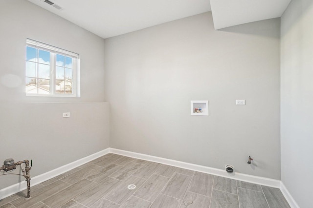 laundry room with hookup for a washing machine, laundry area, wood finish floors, visible vents, and baseboards