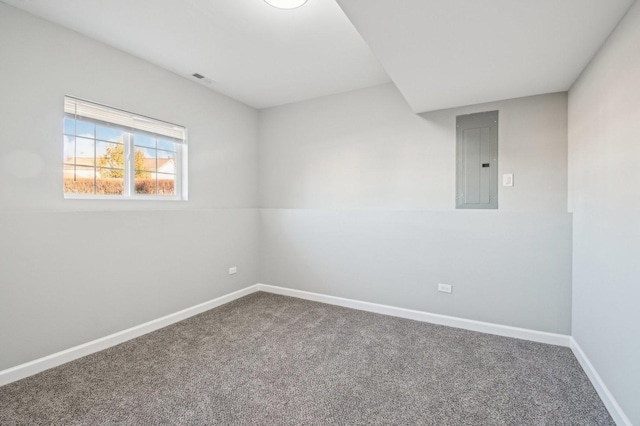 unfurnished room with carpet flooring, electric panel, and baseboards