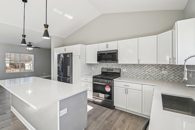 kitchen featuring light countertops, black fridge with ice dispenser, and gas range