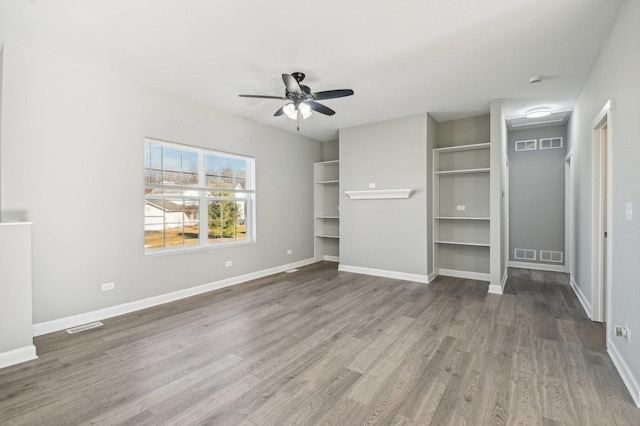 unfurnished bedroom with visible vents, baseboards, and wood finished floors