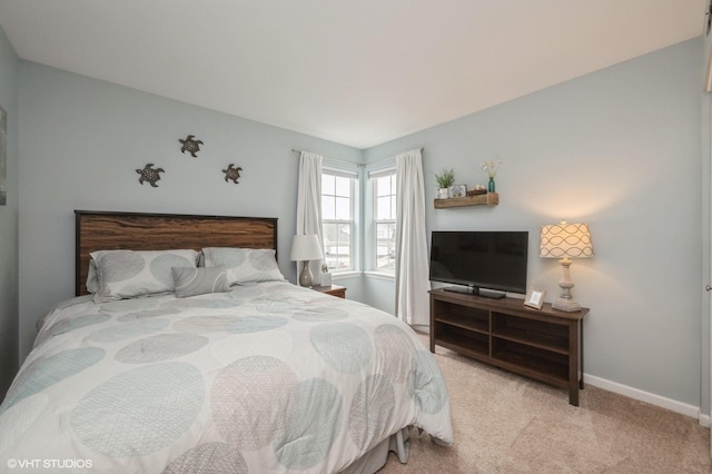 bedroom with carpet floors and baseboards