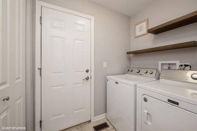 laundry area featuring laundry area, baseboards, visible vents, and washer and dryer