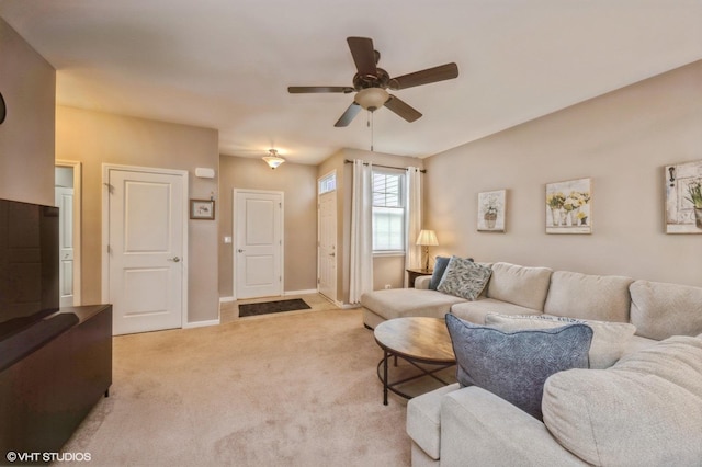 living room featuring light carpet, ceiling fan, and baseboards