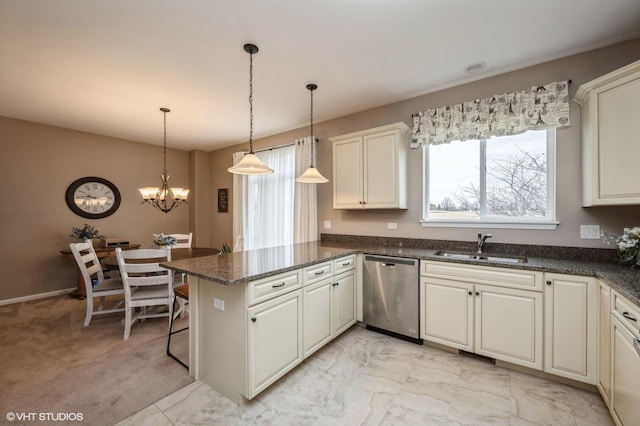 kitchen with a peninsula, a sink, marble finish floor, dishwasher, and pendant lighting