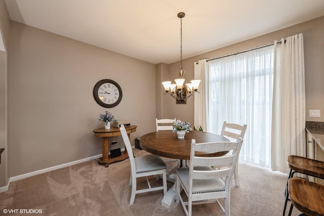 dining area with light carpet, baseboards, and a notable chandelier