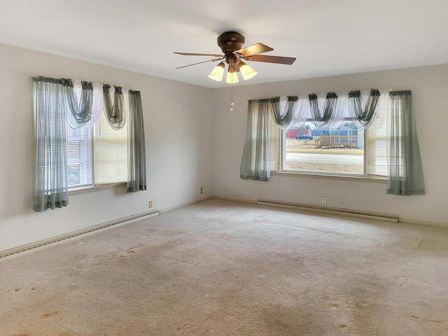 unfurnished room with carpet floors, a baseboard radiator, and ceiling fan