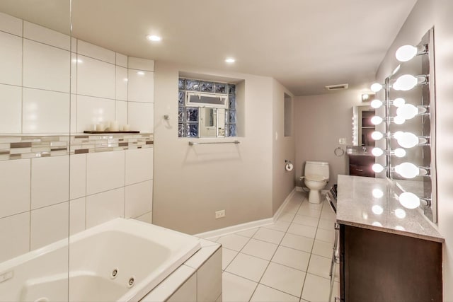 bathroom with visible vents, toilet, vanity, tile patterned flooring, and baseboards