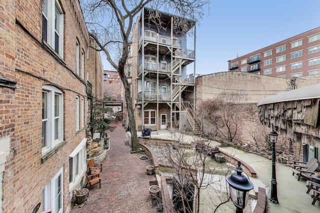 exterior space with stairs and a patio