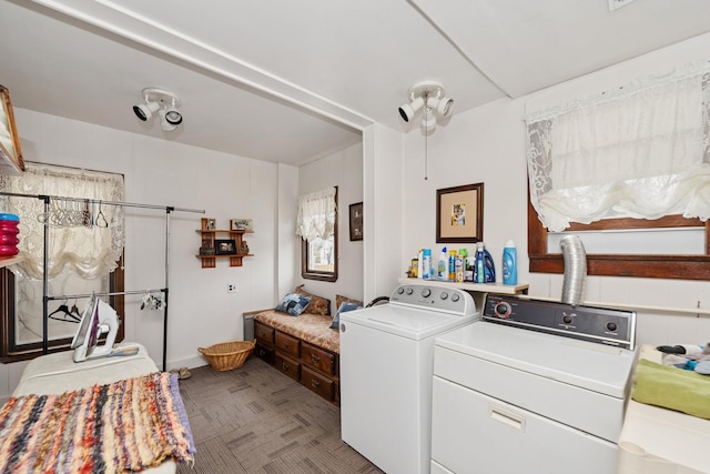 clothes washing area featuring laundry area and washing machine and clothes dryer
