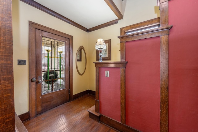 entryway featuring wood finished floors, baseboards, and ornamental molding