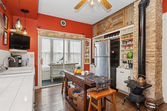 dining space with wood-type flooring and a ceiling fan