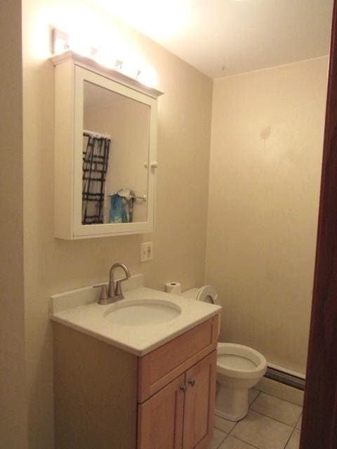 bathroom featuring tile patterned flooring, vanity, and toilet