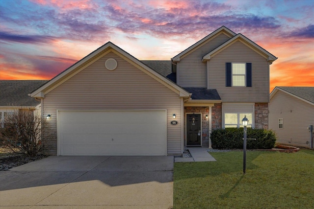 traditional home with concrete driveway, an attached garage, a lawn, and stone siding