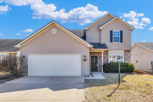 traditional home with stone siding, an attached garage, and driveway