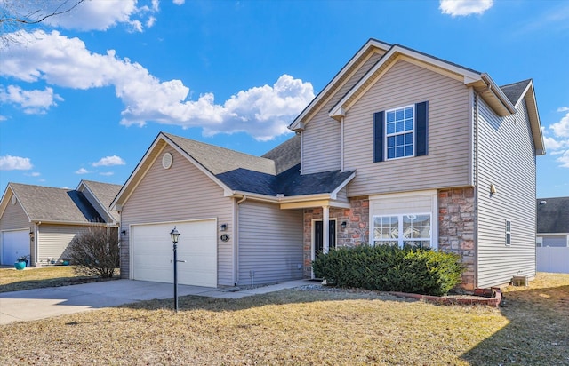 traditional home featuring stone siding, an attached garage, concrete driveway, and a front lawn