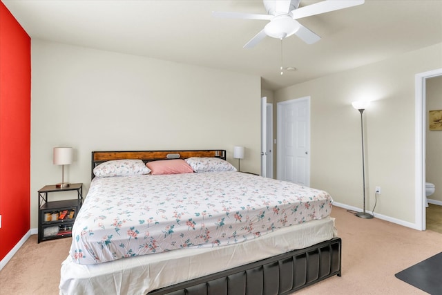 bedroom with light colored carpet, baseboards, and ceiling fan