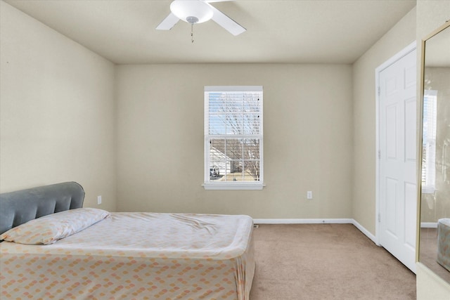 carpeted bedroom with baseboards and ceiling fan