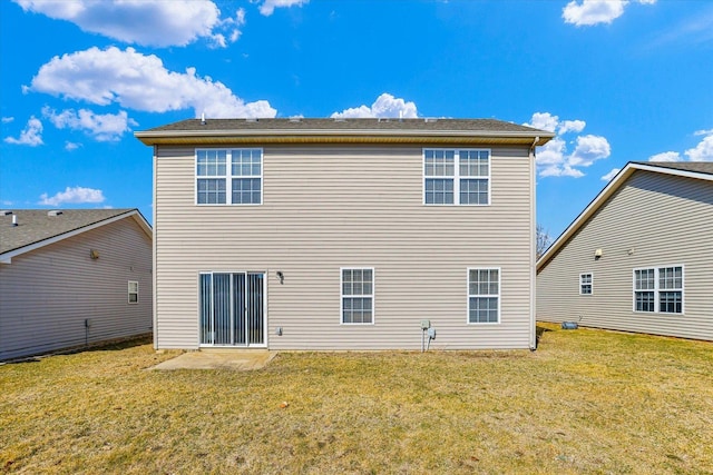 back of house featuring a yard