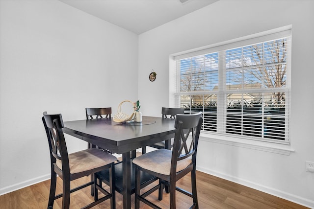 dining area with wood finished floors and baseboards