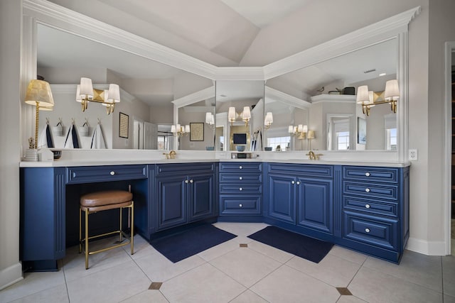 bathroom with lofted ceiling, tile patterned flooring, a sink, and double vanity