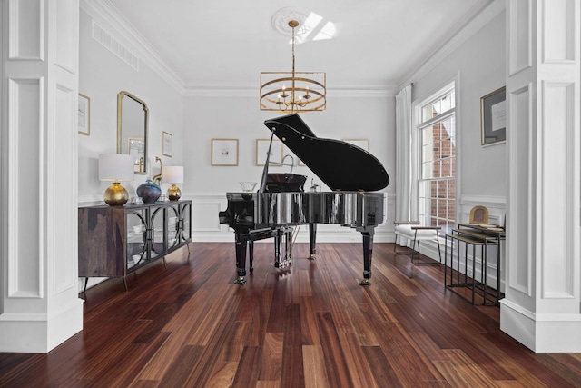 sitting room with ornamental molding, visible vents, a notable chandelier, and dark wood-style floors