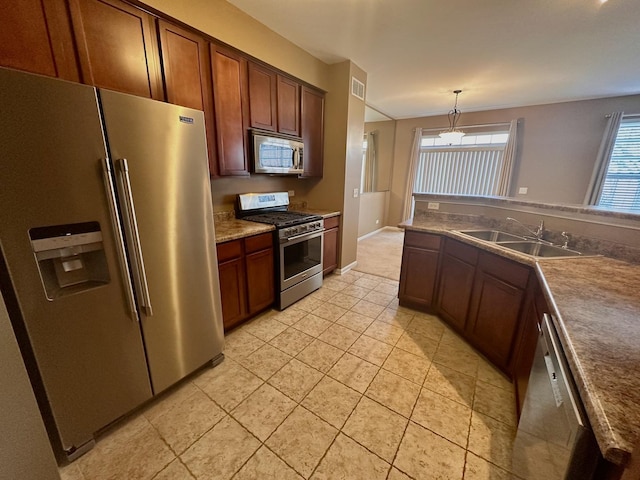 kitchen with light tile patterned floors, visible vents, hanging light fixtures, appliances with stainless steel finishes, and a sink