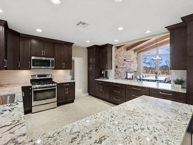 half bath featuring tile patterned floors, toilet, vanity, and baseboards