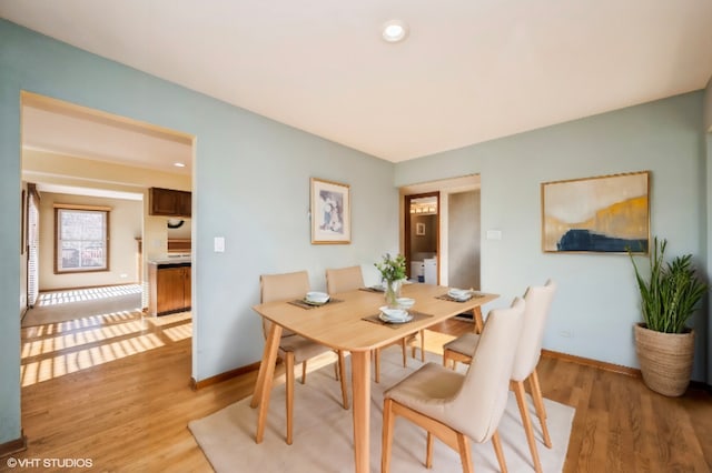 dining room featuring recessed lighting, baseboards, and light wood-style floors