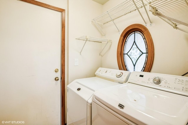 clothes washing area with washing machine and dryer and laundry area