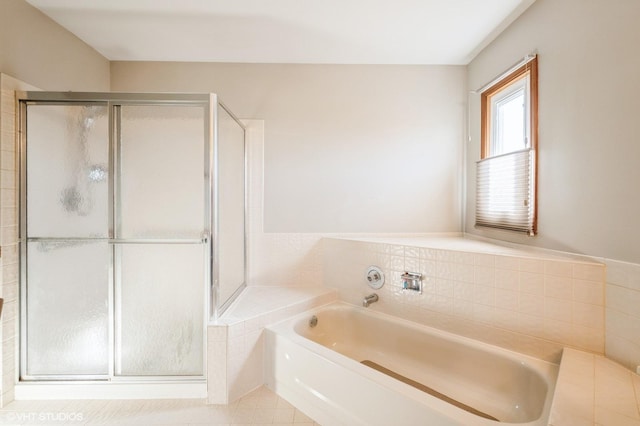 full bathroom featuring a bath and a shower stall