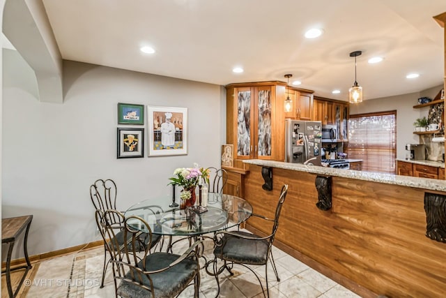 dining area featuring light tile patterned floors, recessed lighting, and baseboards