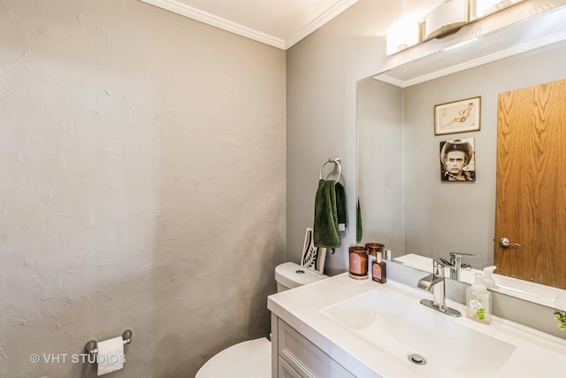 half bath with vanity, toilet, and ornamental molding