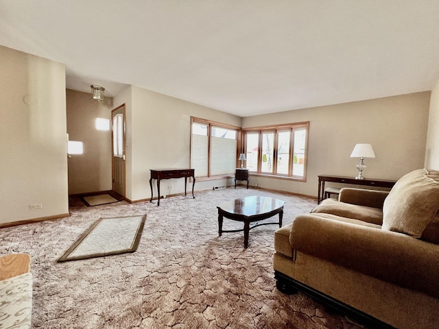 carpeted living area featuring baseboards