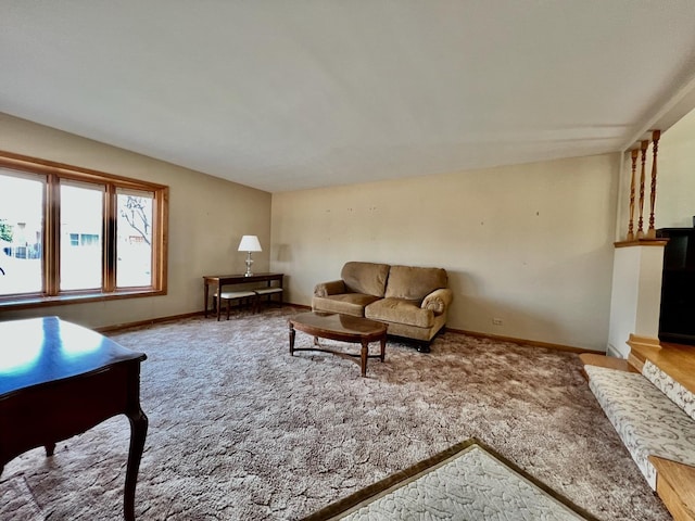 carpeted living room featuring baseboards