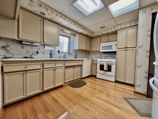 kitchen with visible vents, light countertops, white appliances, and light wood-style flooring