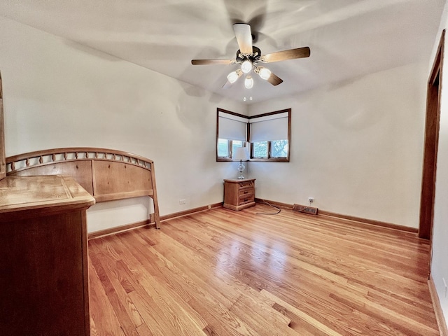 unfurnished bedroom featuring ceiling fan, light wood-type flooring, and baseboards