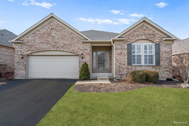 ranch-style home with an attached garage, a front yard, aphalt driveway, and brick siding