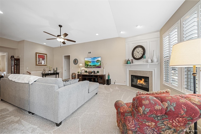 carpeted living area with recessed lighting, baseboards, ceiling fan, and a tiled fireplace