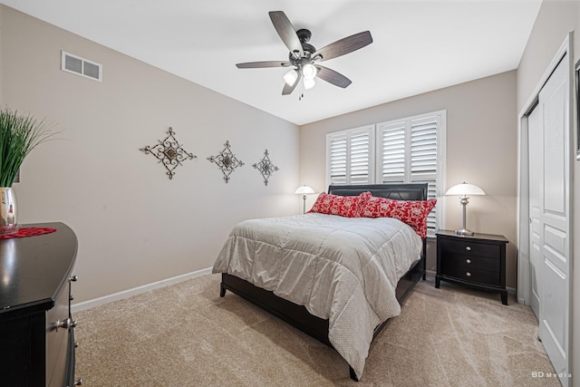 bedroom with light carpet, a closet, visible vents, and baseboards