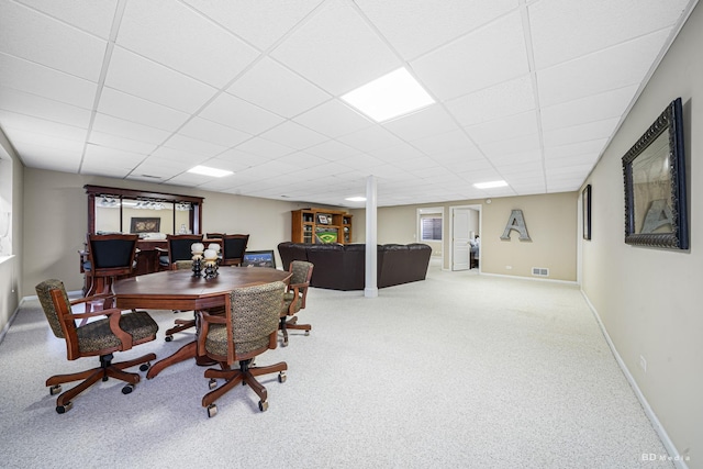 carpeted dining space with a paneled ceiling, visible vents, and baseboards