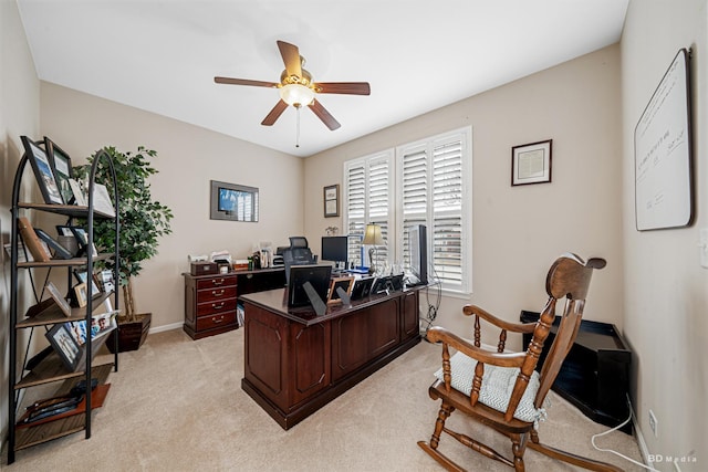 office featuring light carpet, ceiling fan, and baseboards