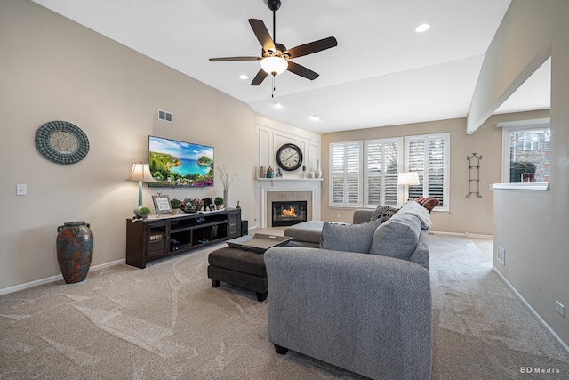 carpeted living room with a glass covered fireplace, plenty of natural light, baseboards, and recessed lighting