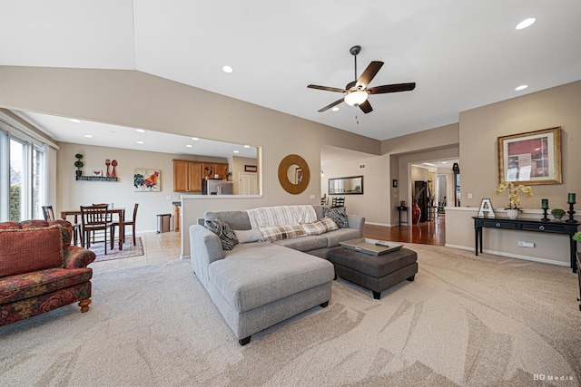 living room with light carpet, vaulted ceiling, a ceiling fan, and recessed lighting