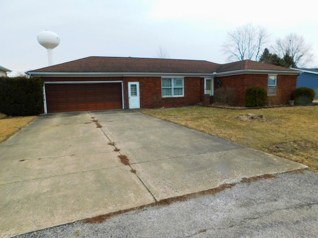 ranch-style house featuring a front lawn, concrete driveway, brick siding, and an attached garage